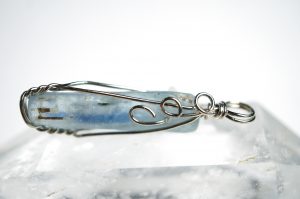 a kyanite pendant wrapped in silver wire